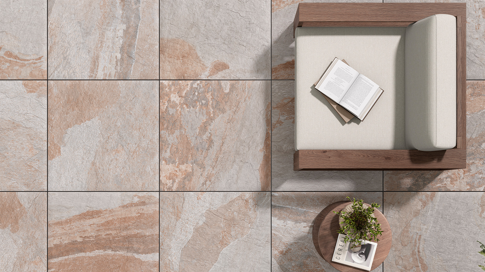 sienna stone porcelain pavers on a patio with a chair and small table with a plant. 