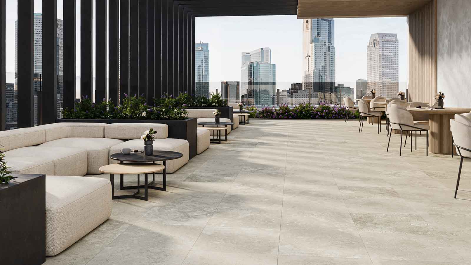 Travertine porcelain pavers on a restaurant roof deck with city skyline view. 