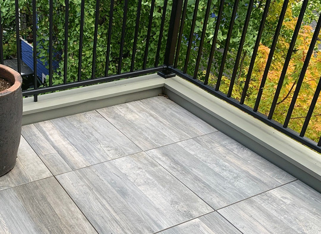 balcony with 24 inch by 24 inch gray porcelain pavers.