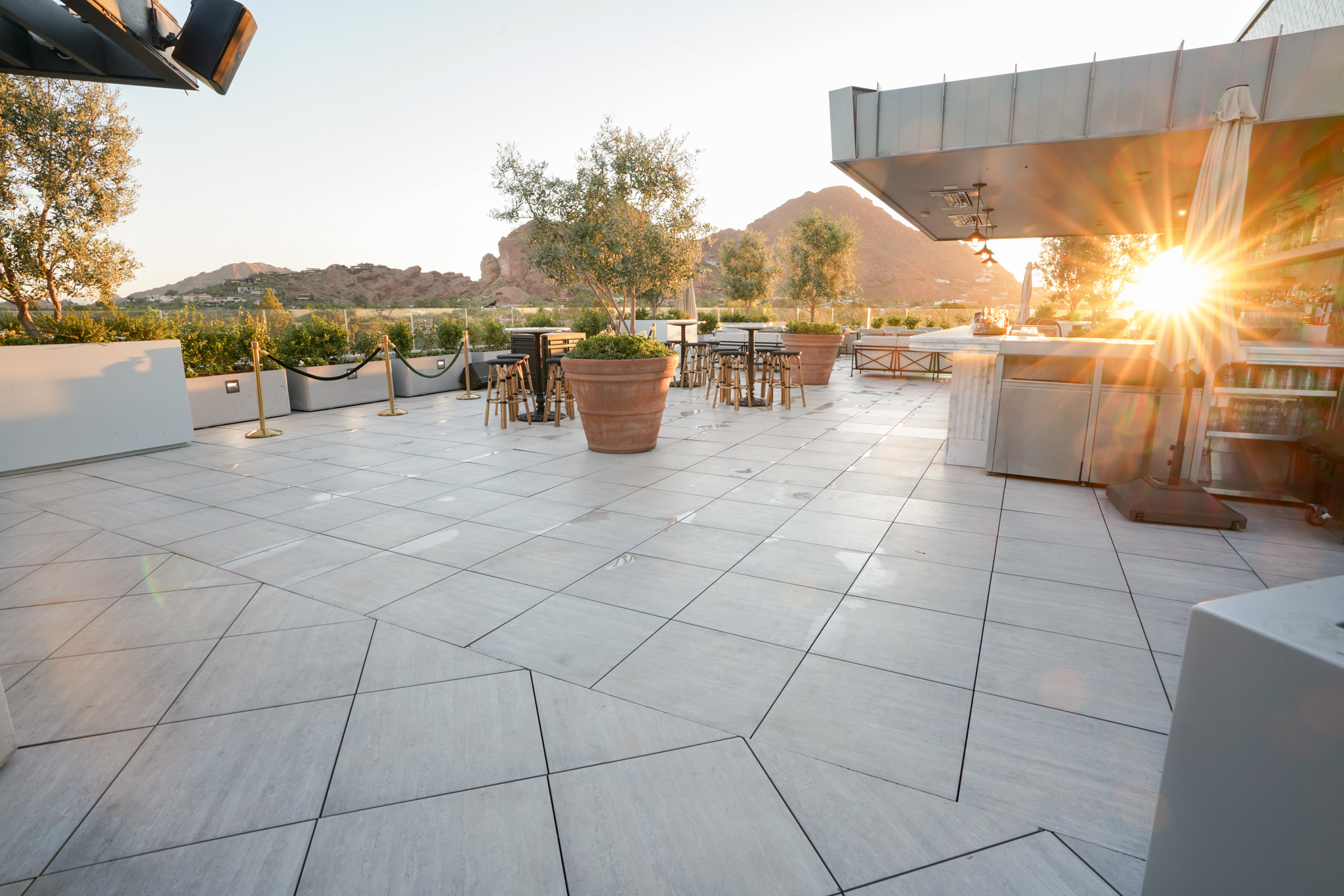 global ambassador hotel roofdeck at sunrise with camelback mountain in distance.