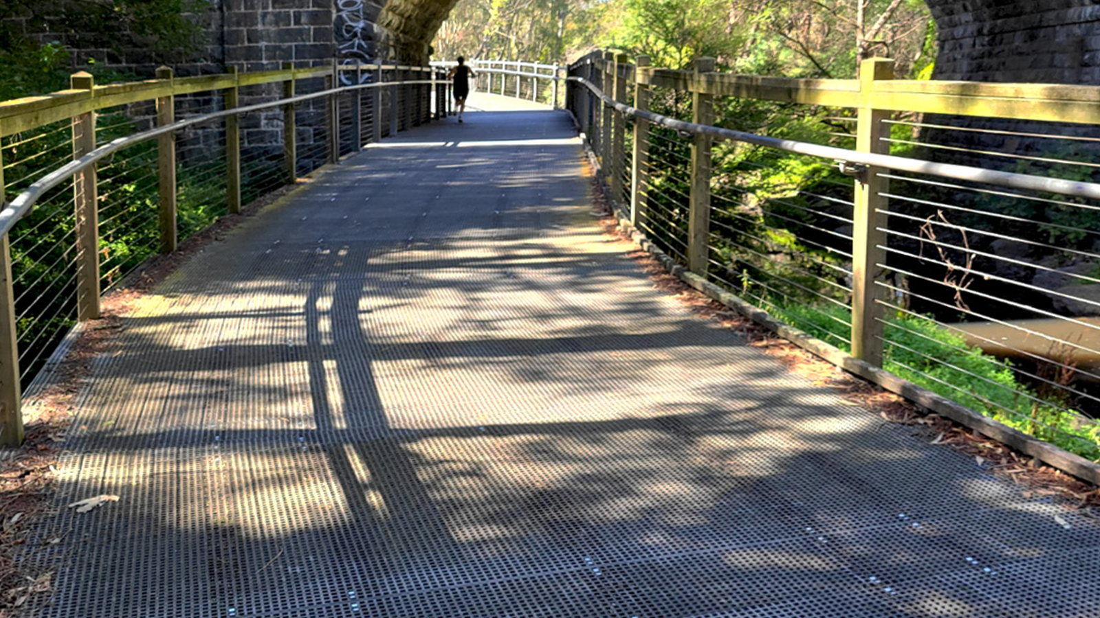frp grating bridge with cyclist biking over it.