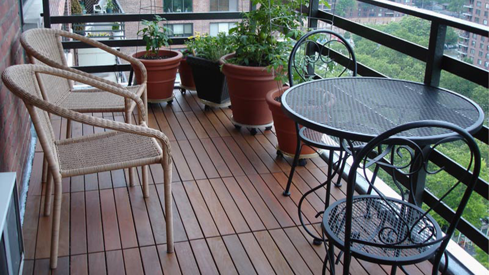 interlocking ipe balcony with table and potted plants. 