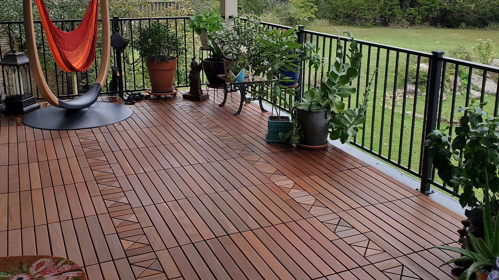 interlocking ipe tiles on a balcony with potted plants.
