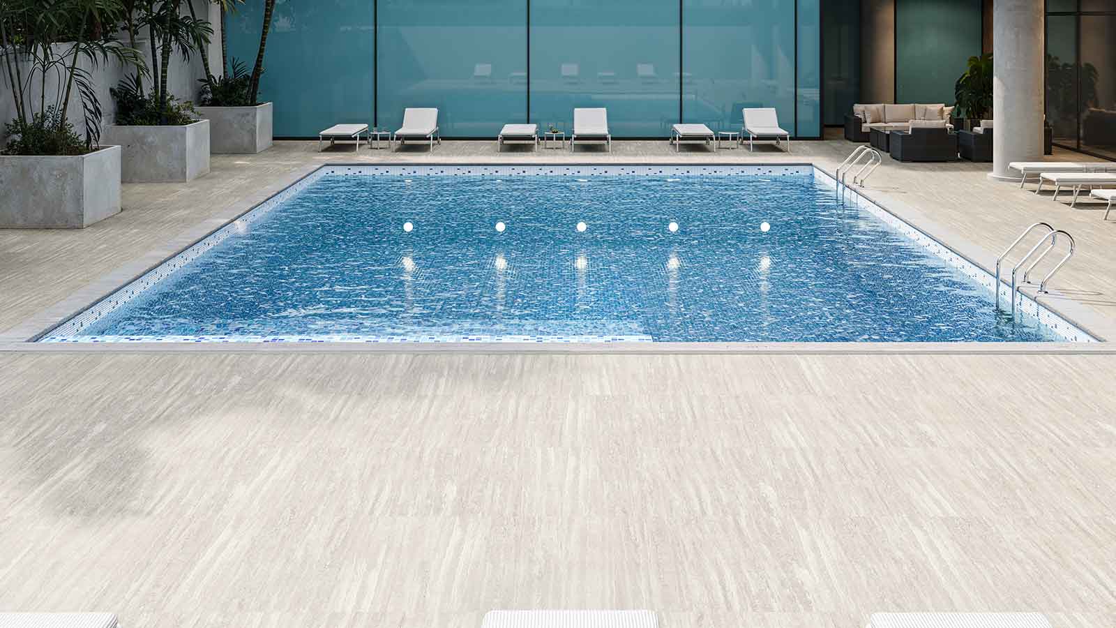 Travertine porcelain pavers around a hotel pool. 