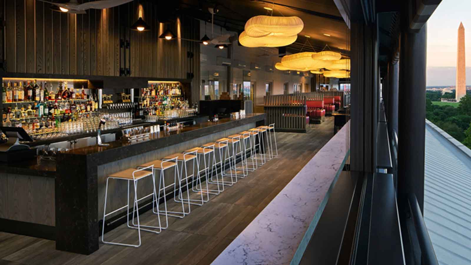 bar with lights overhead and wood look porcelain paver floors.