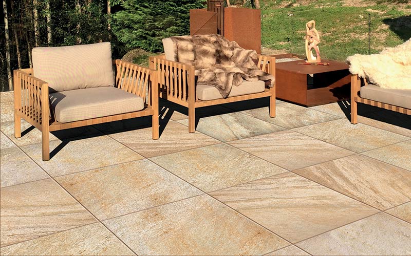This image depicts an outdoor patio space with furniture and Archatrak porcelain pavers.