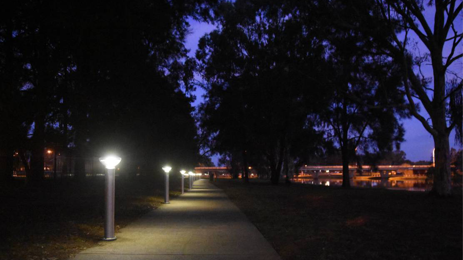 solar bollards at dusk on a walking path. 