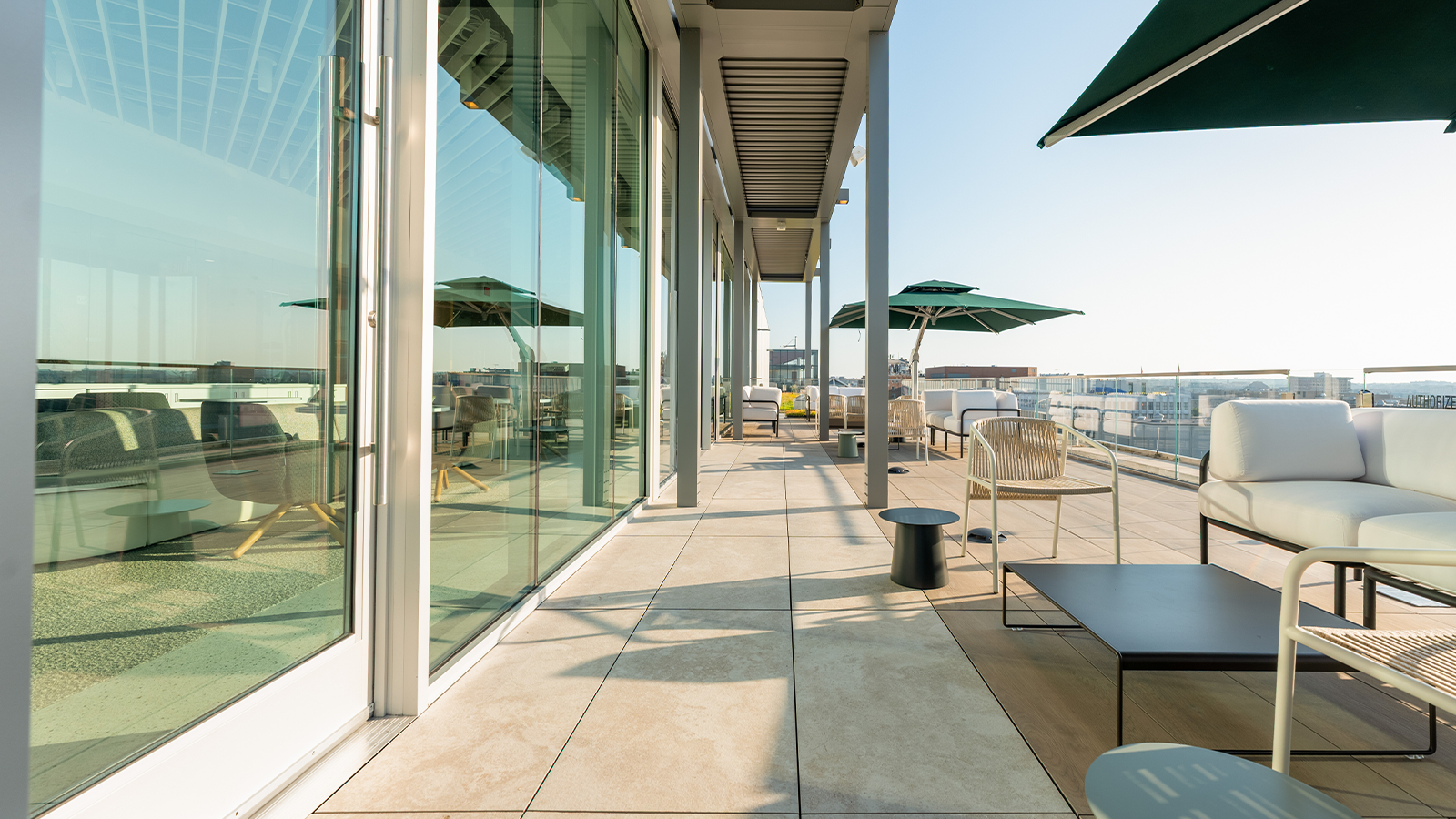 roof deck at sunrise with chairs and umbrellas