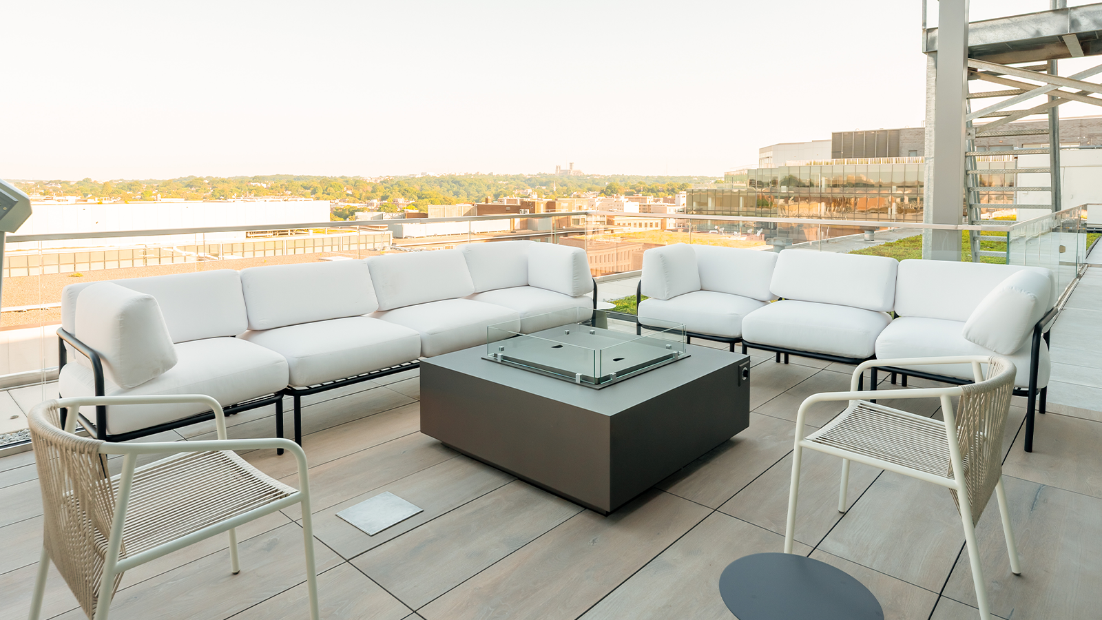 roof deck with white couches and fire pit sitting area. wood look porcelain planks for surface 