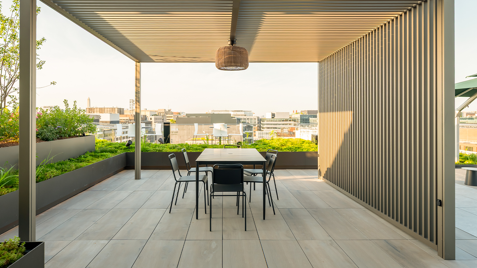 rooftop deck dining area with table and woodlook porcelain plank flooring