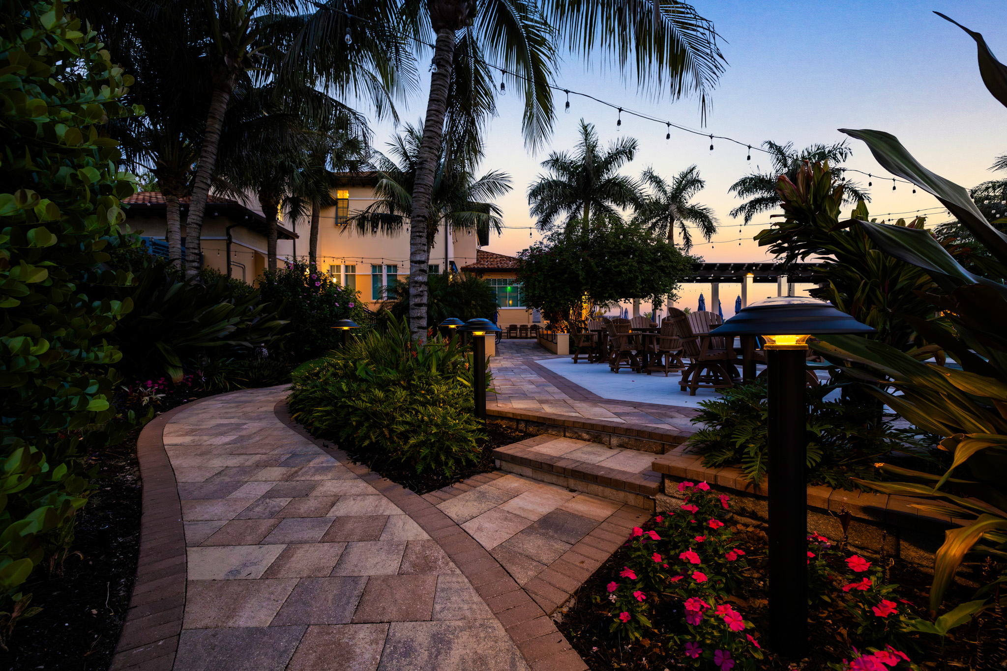 solar bollards at dusk at yacht club garden patio