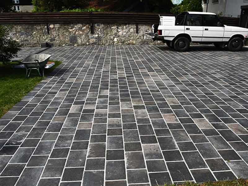 porcelain cobblestone driveway with white suv