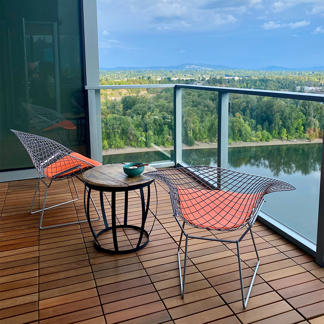 interlocking ipe balcony with small table and two chairs.
