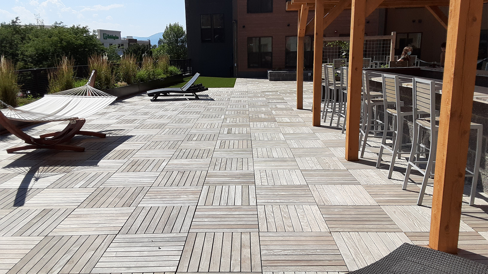 Large ipe structural tile wood deck with alternating tile laying. 
