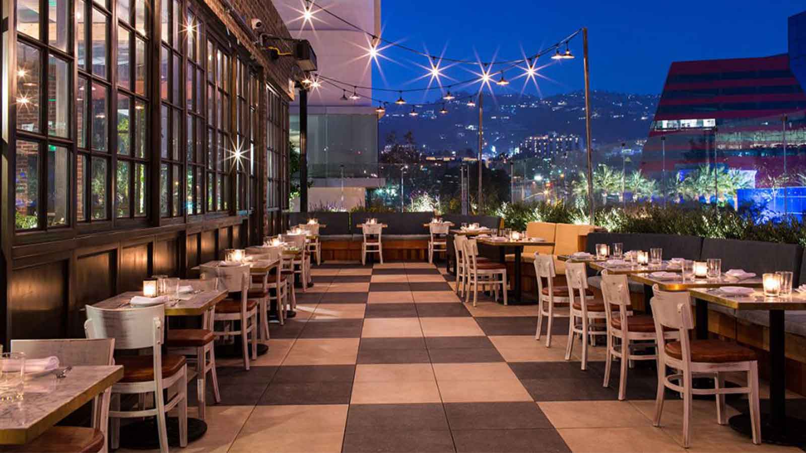 catch la restaurant at night with porcelain paver flooring in two colors square pattern.