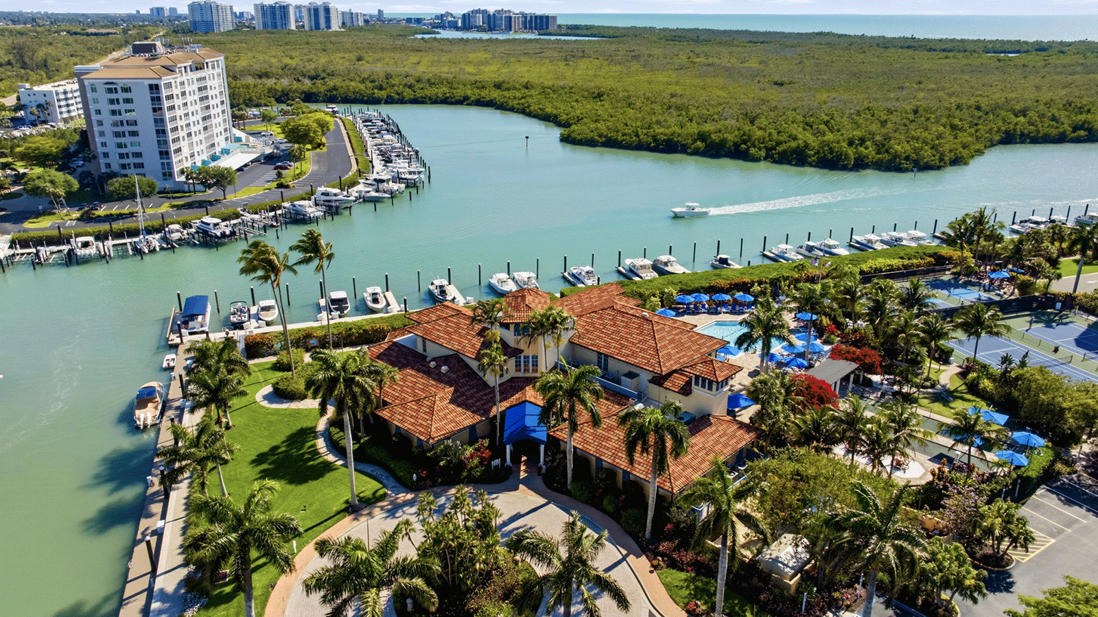 arial view of the pelican bay yacht club in Florida, bay in the backdrop with club in the foreground. 