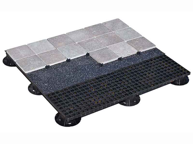 grey porcelain cobblestones laid over rubber mat over FRP panels.