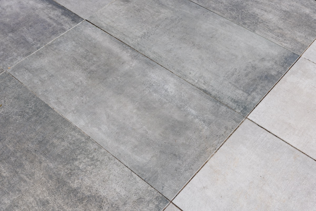 detail close up view of two porcelain paver colors laid side by side on a roof terrace. 