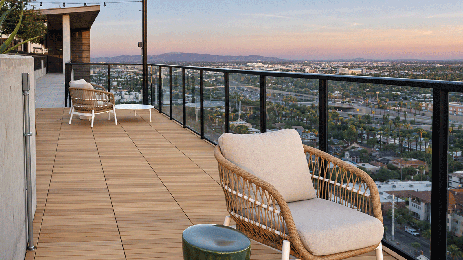 roof deck with light colored 24x24 square deck tiles as surfacewith clear glass balcony railing