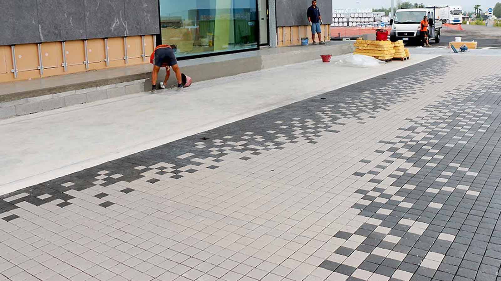 dark grey and taupe cobblestone blocks on a road or driveway.